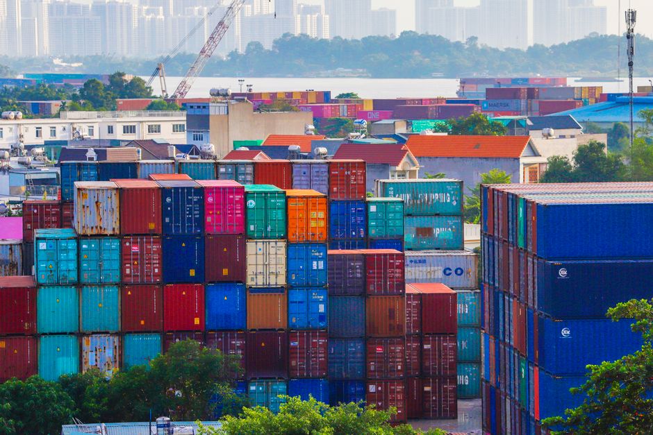 Business professionals discussing international supply chain coordination