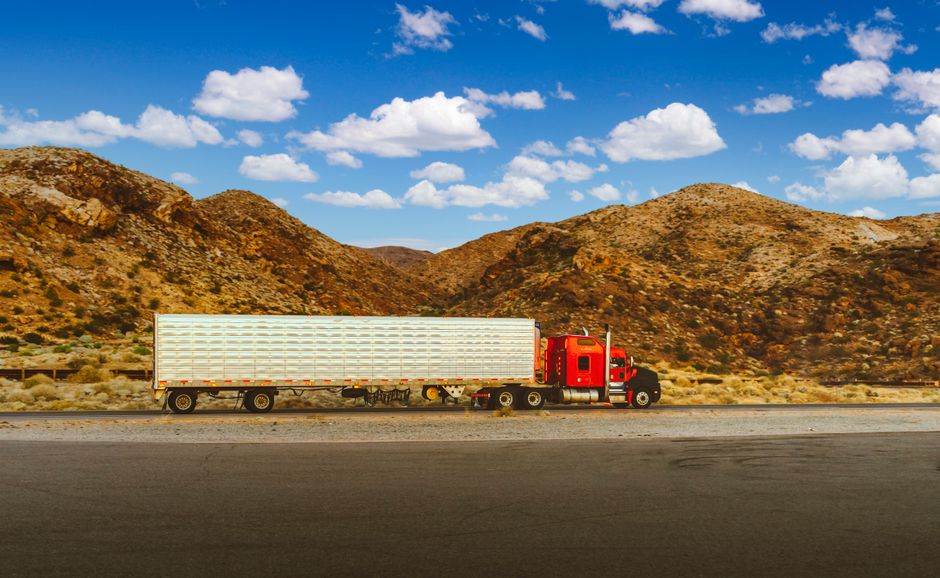 Modern semi trucks on an American highway at sunrise