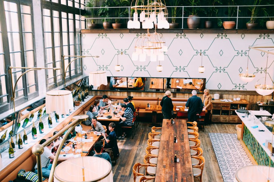Guests enjoying meals in a lively modern restaurant setting