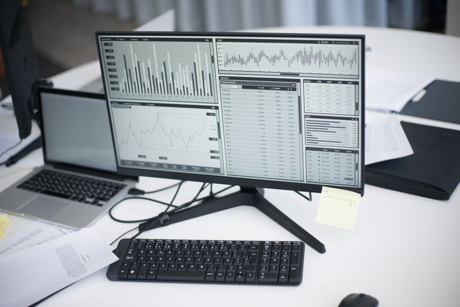 A forensic specialist examining digital data on a computer workstation