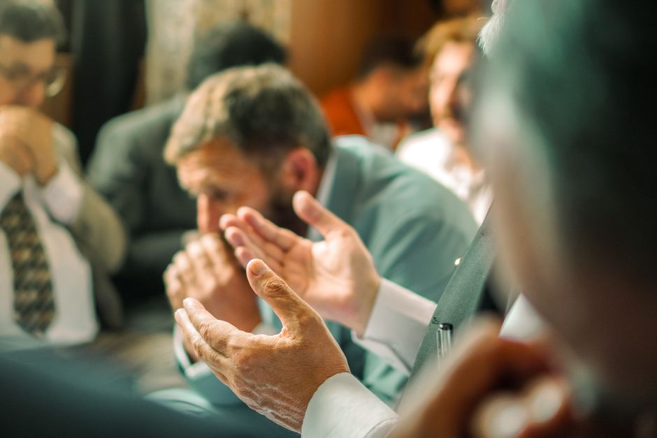 Prayer meeting with people holding hands