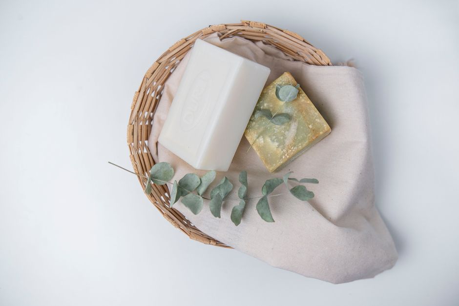 Collection of natural handmade soaps with leaves and herbs