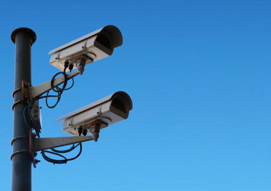 A modern CCTV camera mounted to monitor an exterior area.