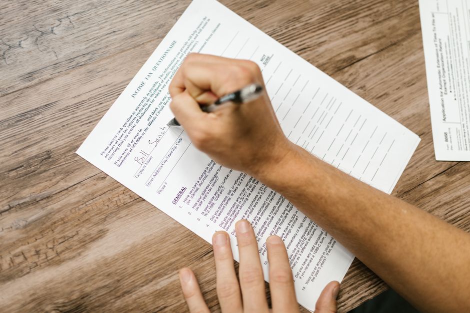 A person completes a sleep screening form at a desk