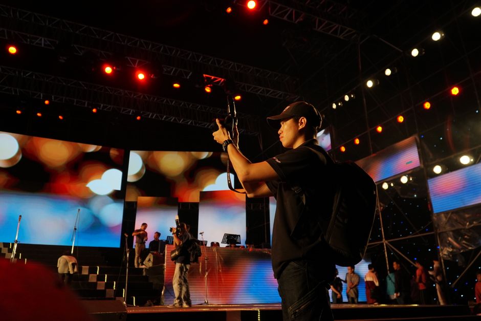 Team coordinating sound and lights backstage at a live event