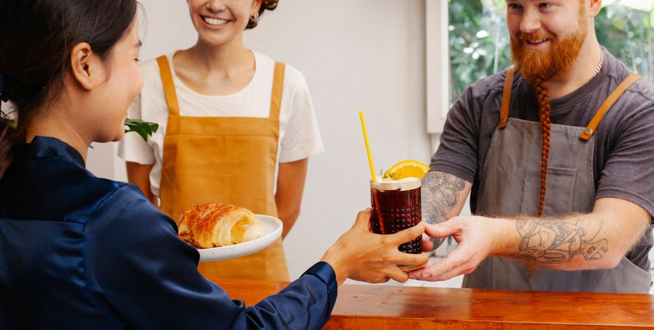 Customer receiving an SMS campaign with an offer in a cafe
