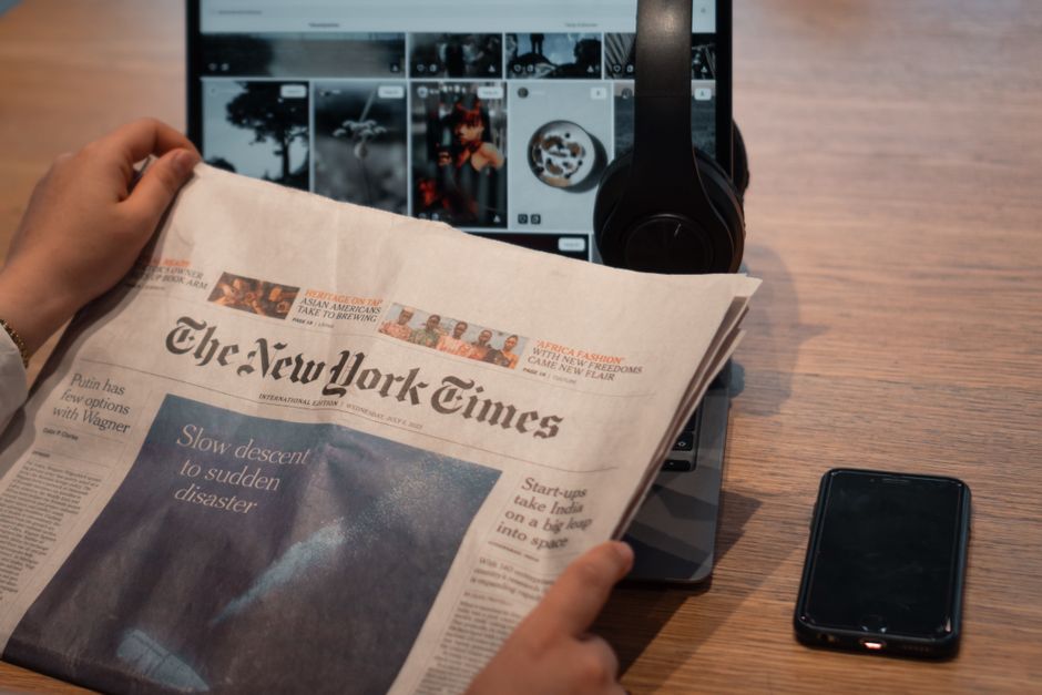 Digital devices displaying news articles and a website