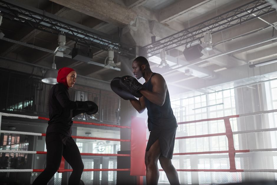 Boxing training session with coach and students practicing punches
