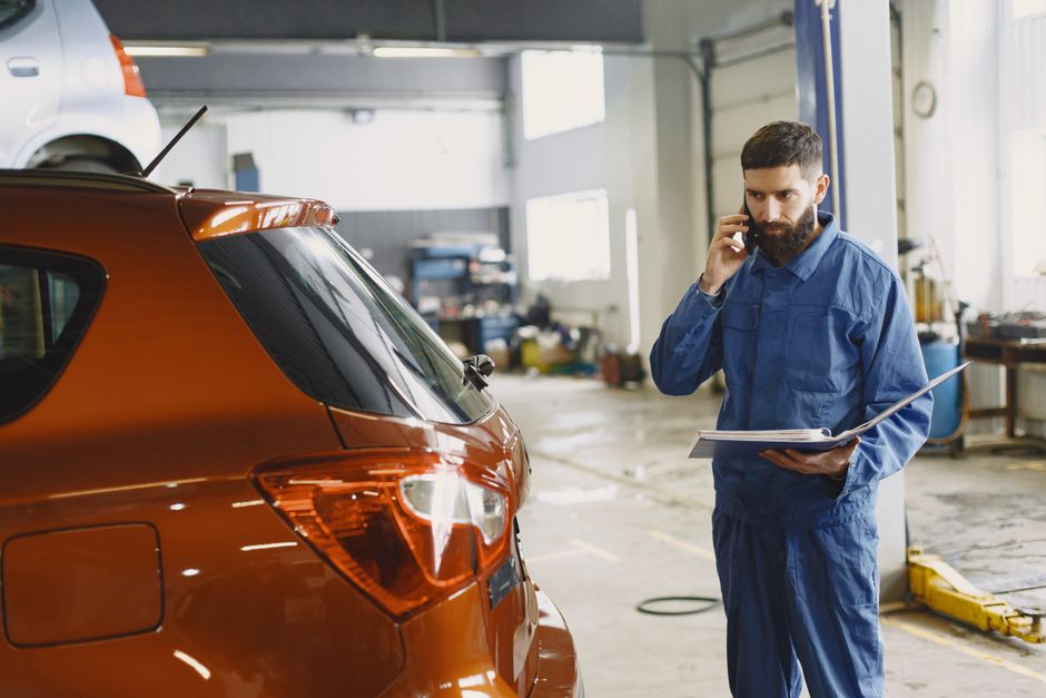 Customer vehicle inspection at car workshop