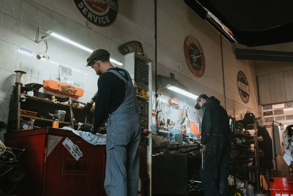 Auto repair technicians discussing a vehicle repair plan