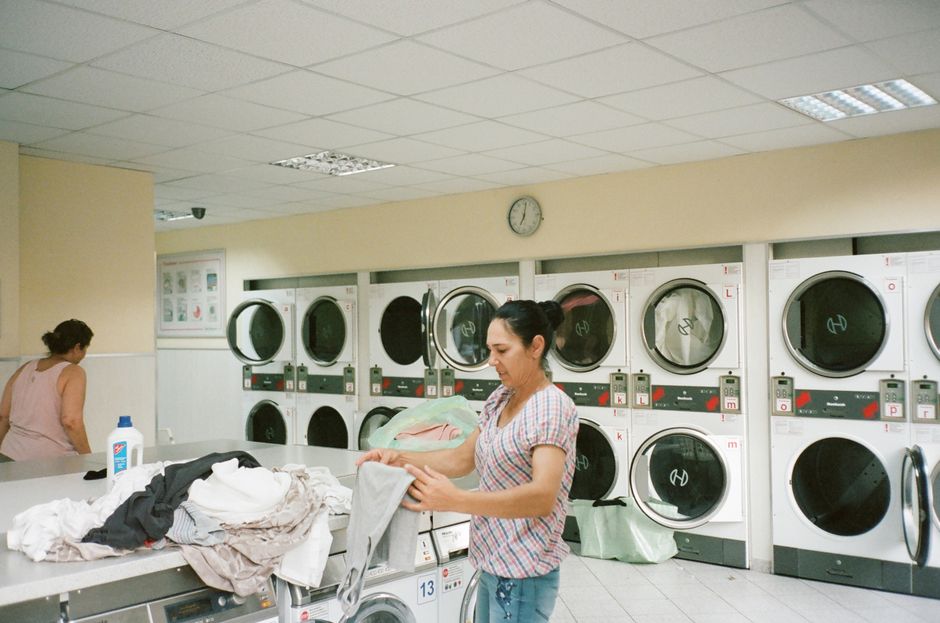 Attendant folding clean laundry with fresh towels