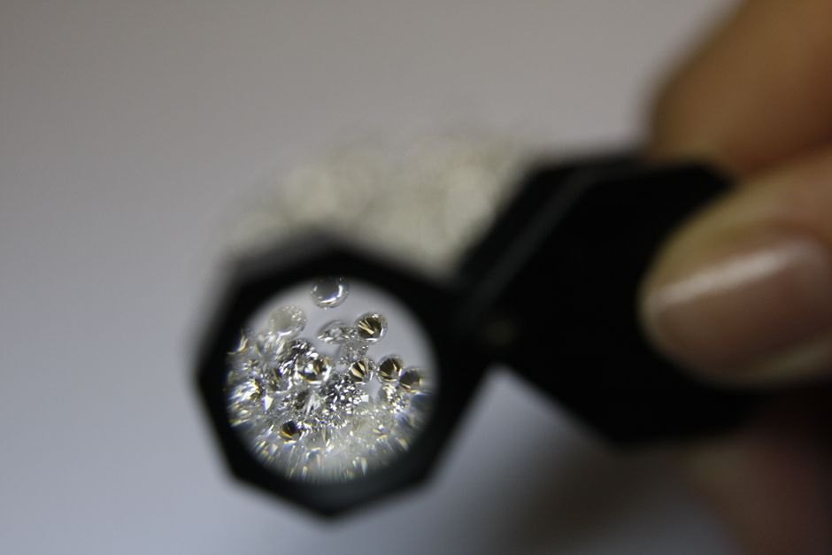 A jeweler skillfully examining diamonds at a workbench