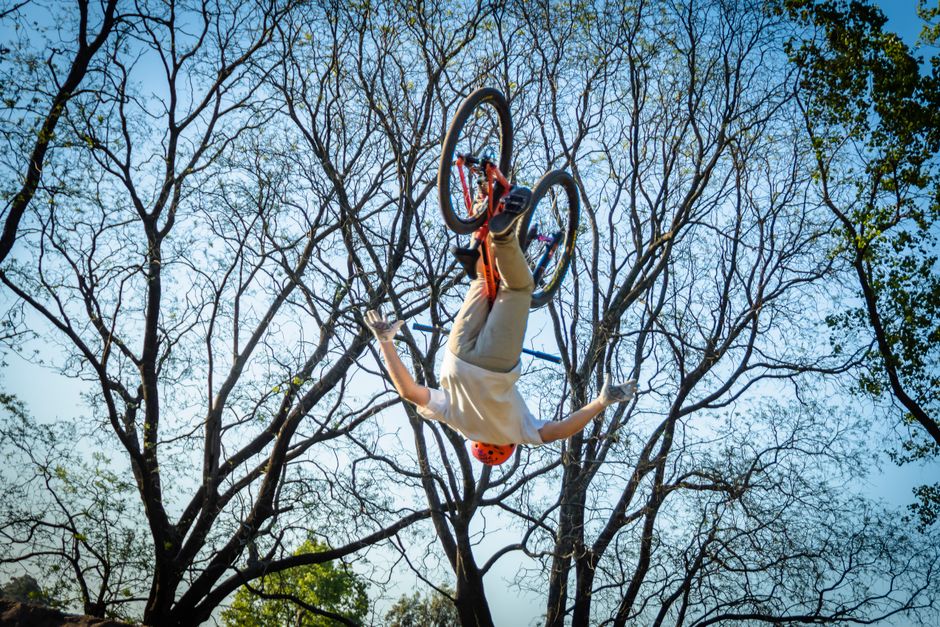 BMX rider performing a trick during a school assembly