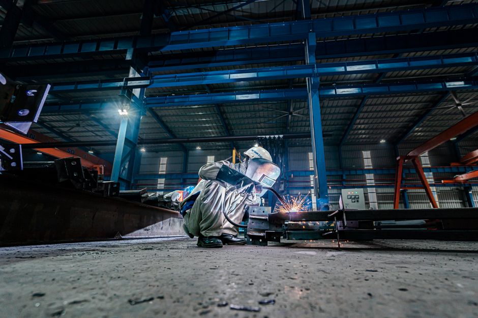 Steel fabrication workshop with heavy equipment and metal frames