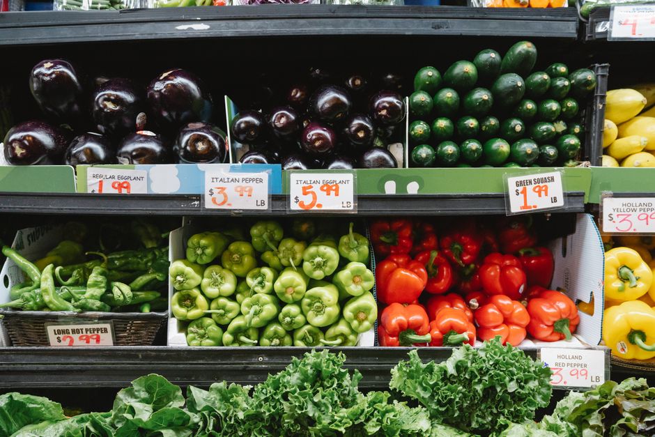 Fresh fruits and vegetables on display in a supermarket produce section