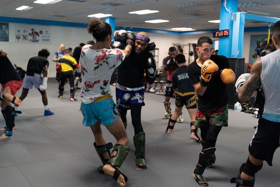 Kickboxing group class in progress at a sports gym