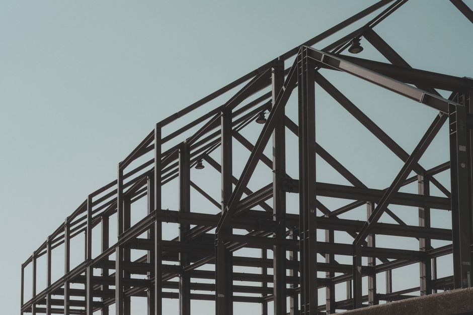 Steel construction engineers discussing plans at a building site