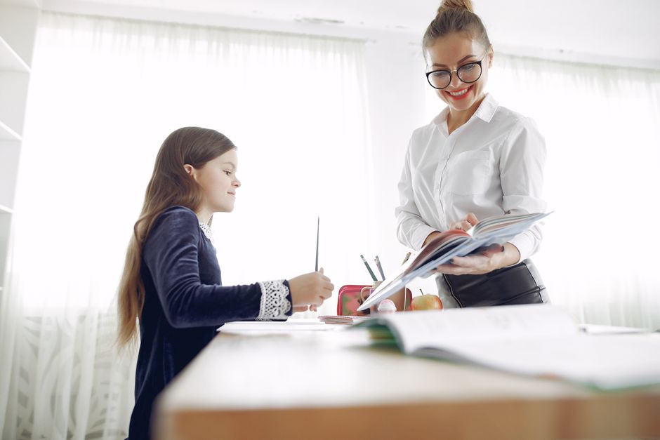 Elementary student working with a tutor in a classroom setting