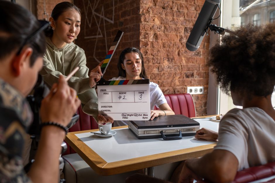A team meets around a table discussing a film project