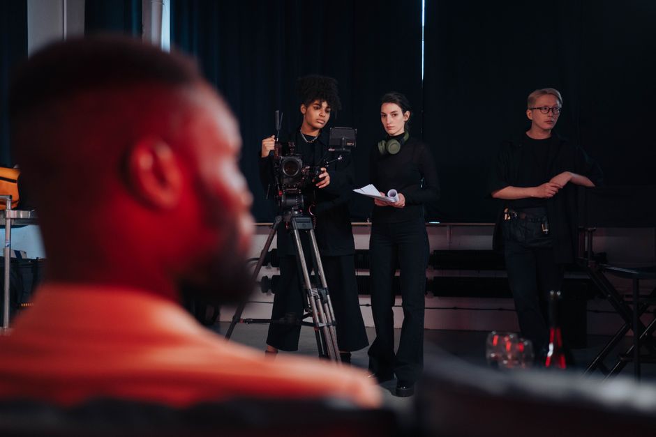 Team of diverse creatives collaborating in a modern production studio