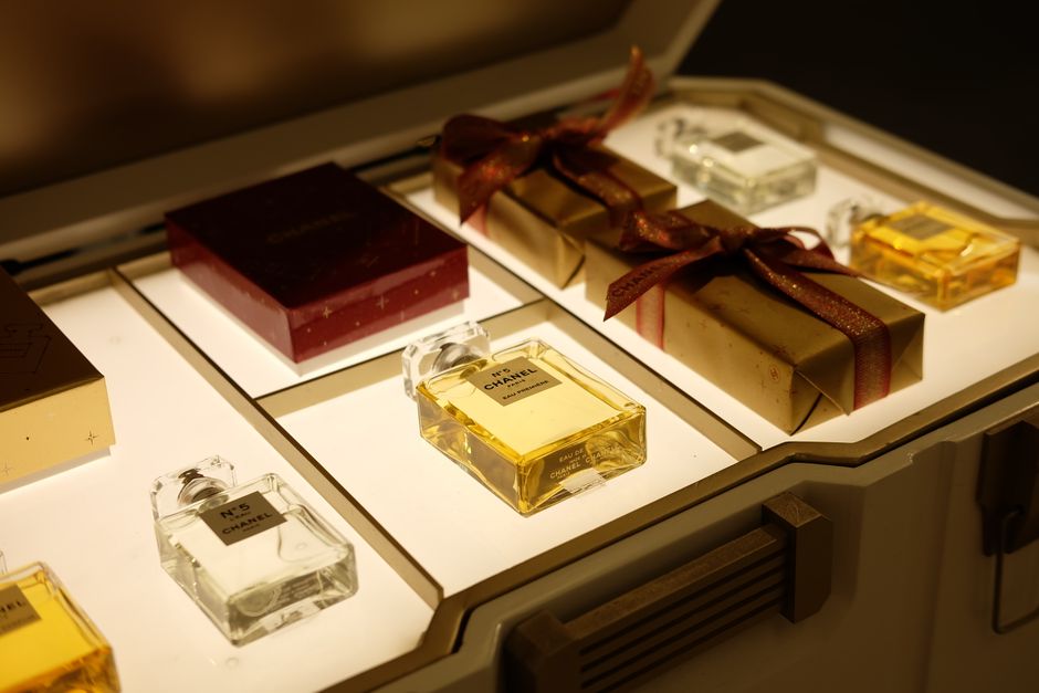 Close up of a staff member wrapping perfume with care.