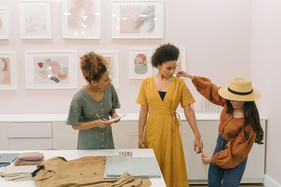 Framing professionals carefully handling art and textiles in a studio.