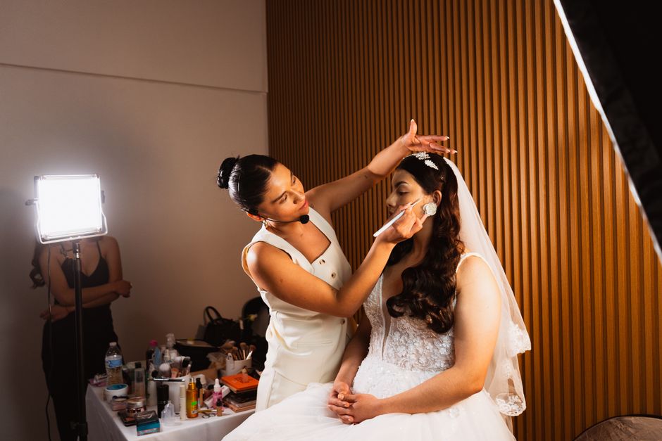 Professional makeup artist applying bridal makeup