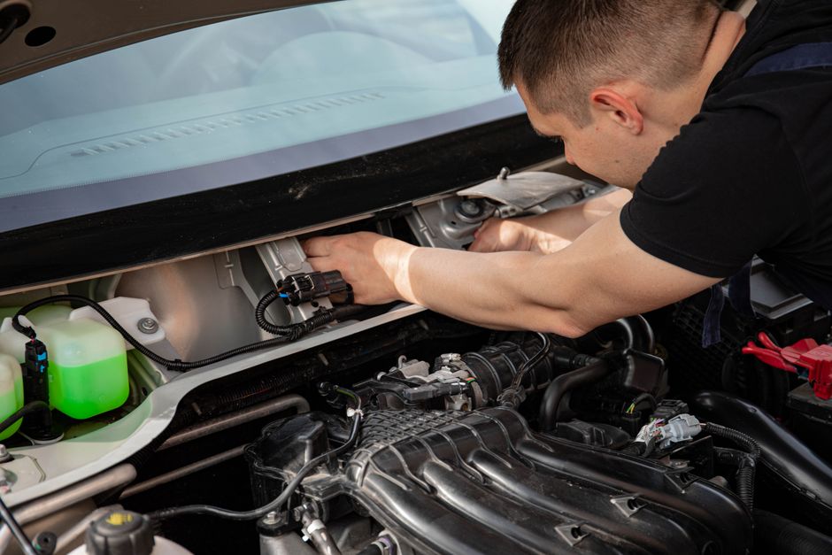 Mechanic conducting an MOT test on a vehicle