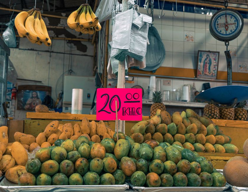 Pineapples and mangoes ready for distribution at a logistics hub