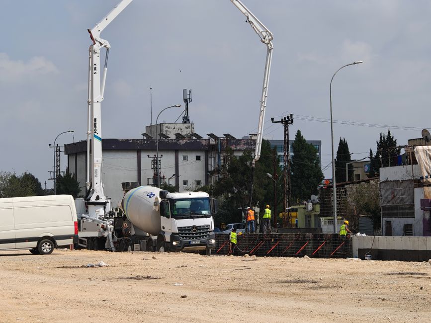 Concrete mixer truck delivering material to a construction site