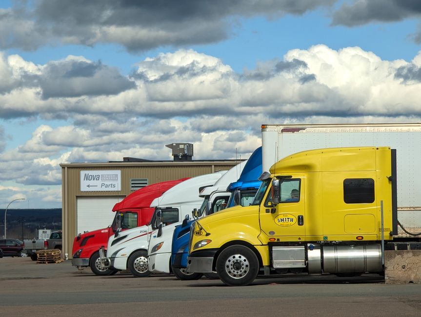 Fleet of commercial trucks ready for material transport
