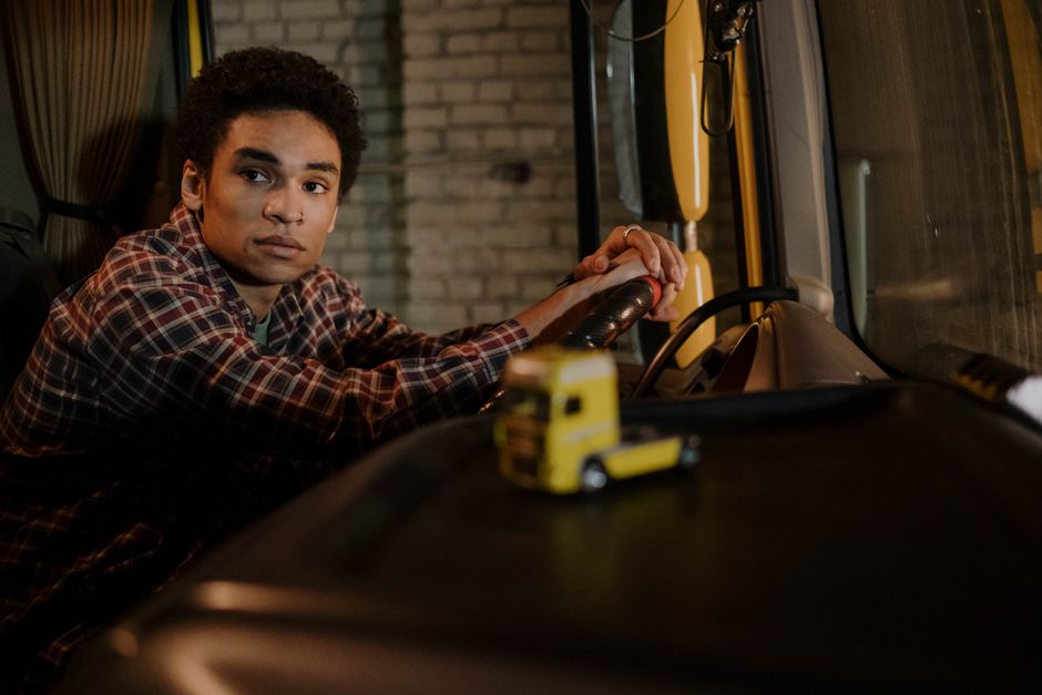 Truck driver conducts a pre-trip inspection before departing with commercial freight