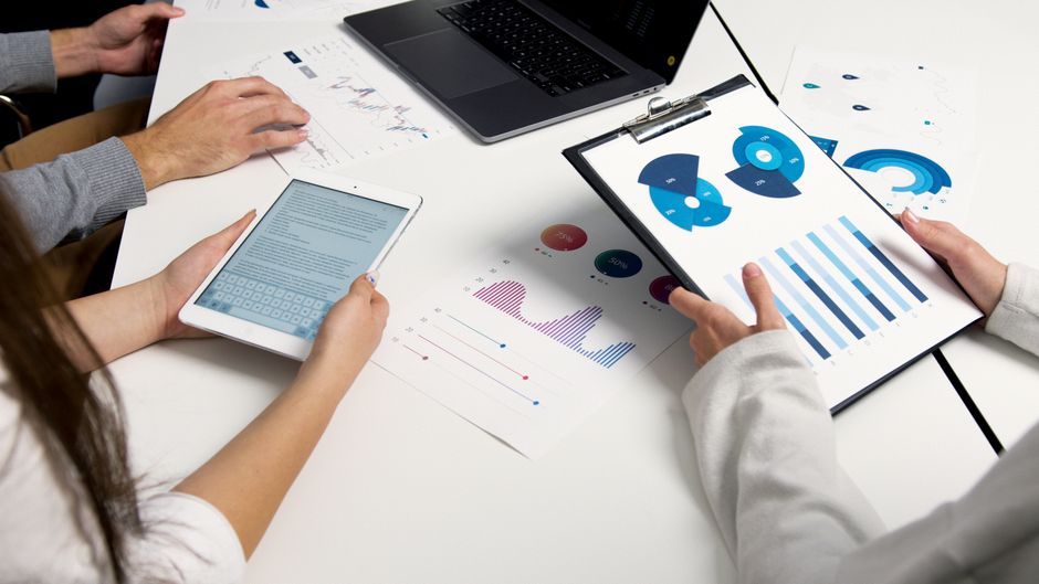 Sales professionals reviewing performance charts and sales data
