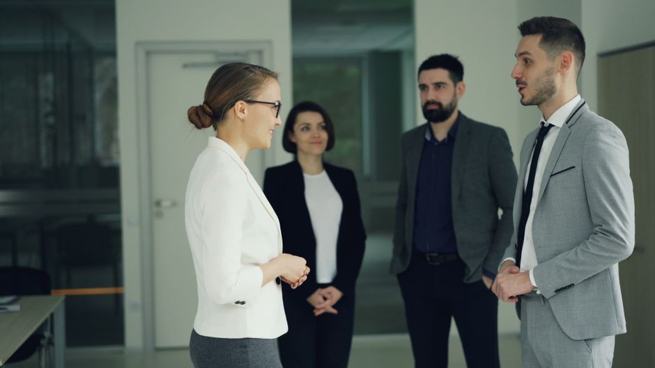 Office staff in discussion at an international trade company