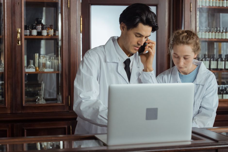 Pharmacists collaborating behind the counter in a modern pharmacy