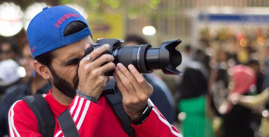 Photographer taking candid photographs at an event