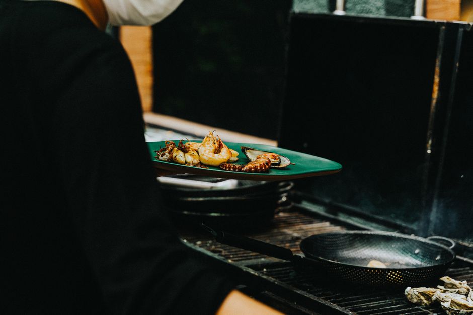 A chef preparing seafood in a bright, modern kitchen.