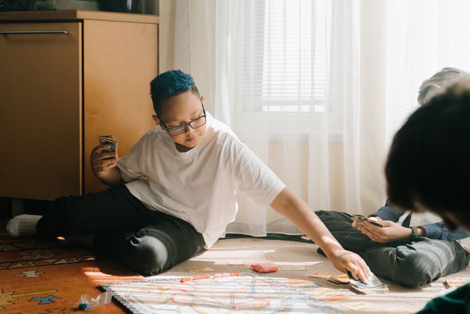 Kids and families playing board games together