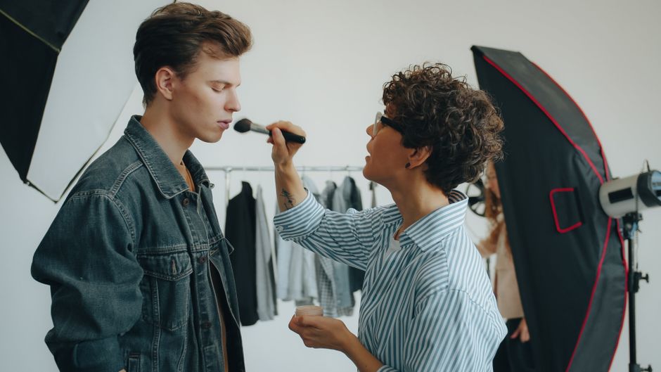 Stylist preparing outfits for a commercial photo shoot on set