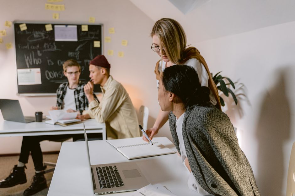 Small tech studio team collaborating in a modern office