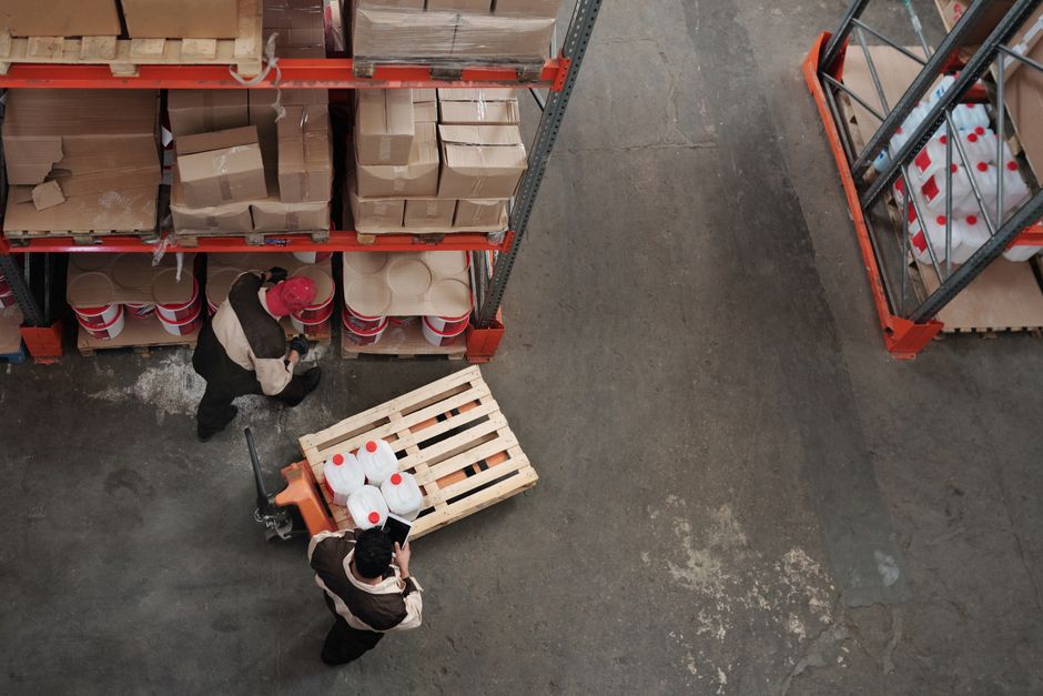 A commercial fumigation team applying treatment in a large warehouse environment