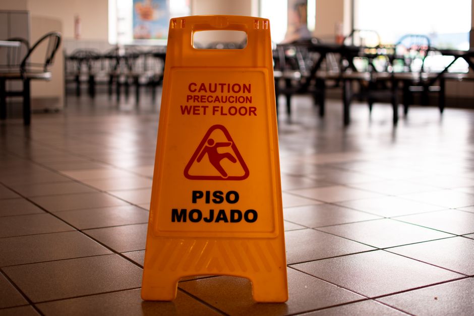 Wet floor warning sign inside a building where a slip has occurred