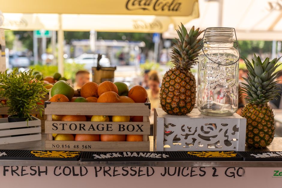 A modern juice bar with fresh fruit on display and glasses of cold-pressed juice