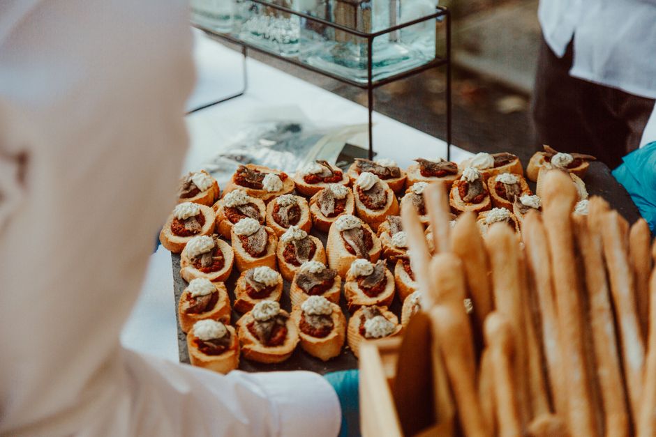 A catered coastal event with dishes on a banquet table.