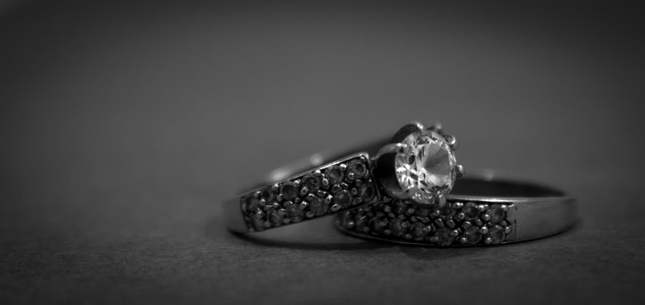 A pair of matched diamonds displayed on a black surface