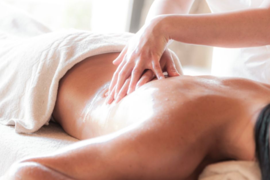 A wellness therapist performing a relaxing massage session for a client.