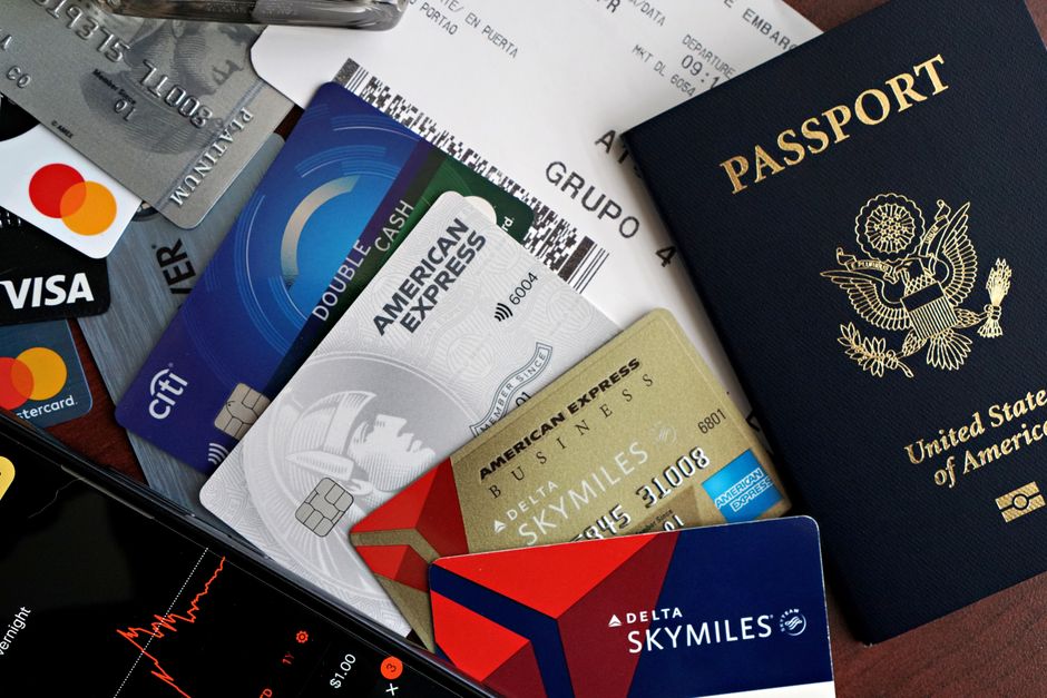 Hands holding credit cards showing rewards points