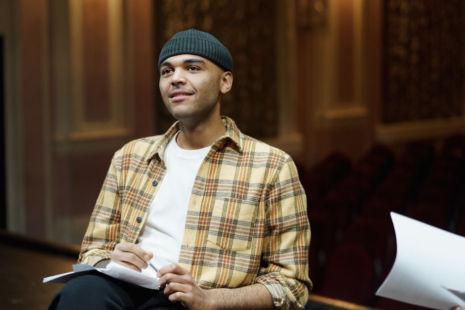 A playwright sharing a script during a staged reading event