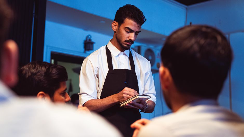 Family-run restaurant team welcoming guests in a cozy setting