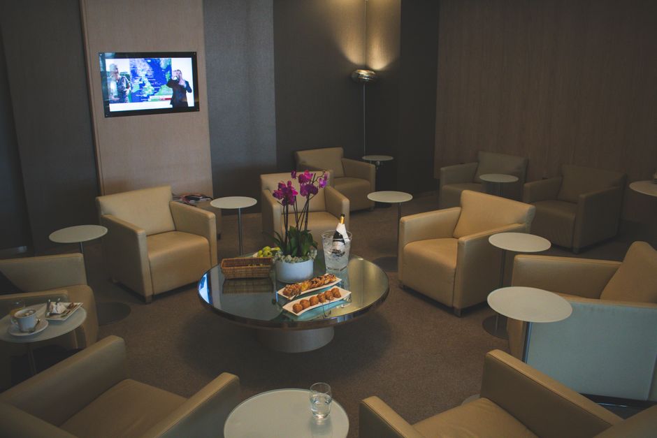 Satisfied traveler relaxing in airport lounge